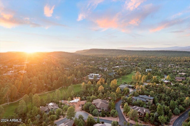 aerial view at dusk featuring a mountain view