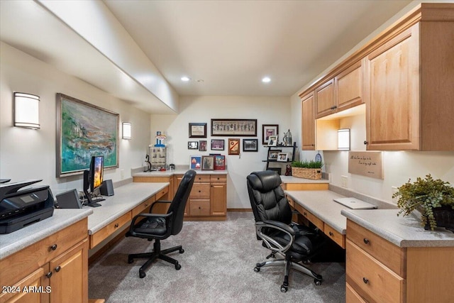 carpeted office space with built in desk