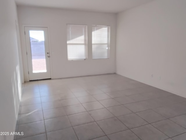 spare room featuring light tile patterned floors