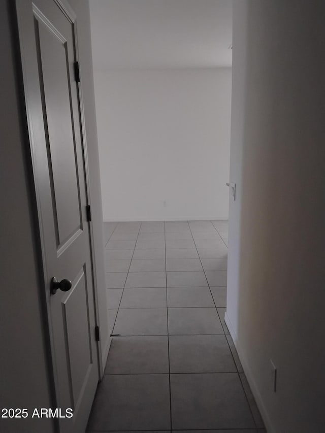 hall featuring light tile patterned floors