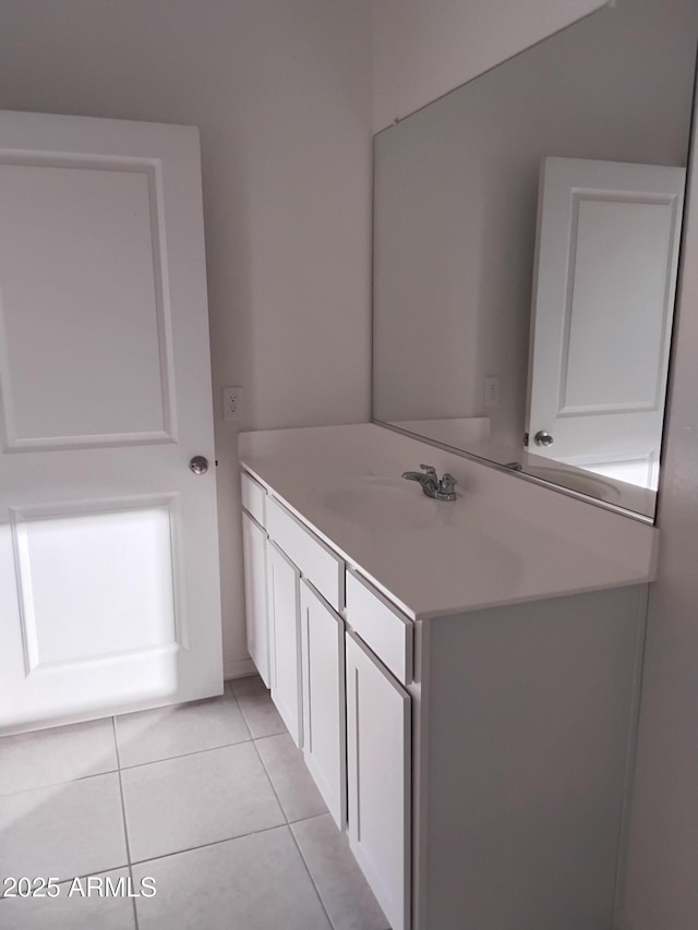 bathroom featuring tile patterned flooring and vanity