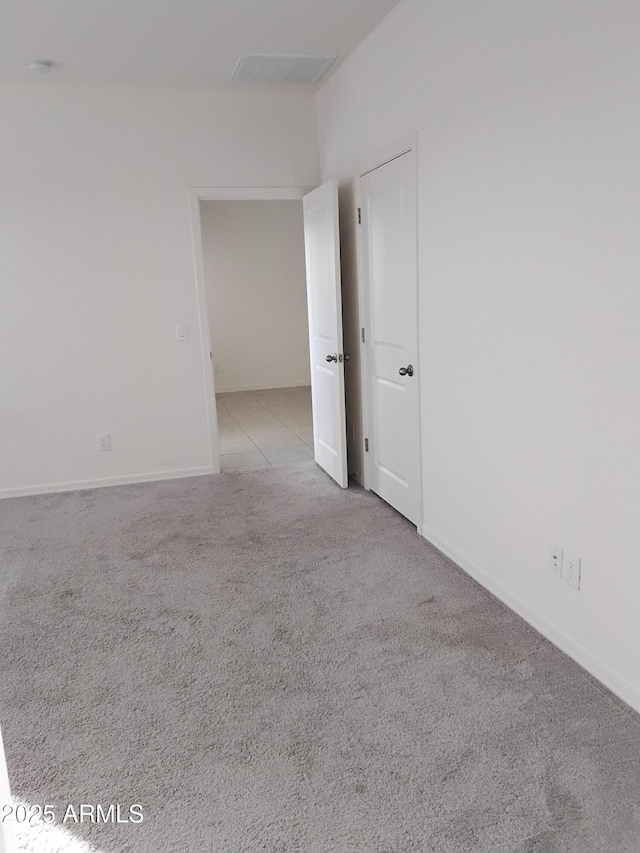 unfurnished room with light carpet