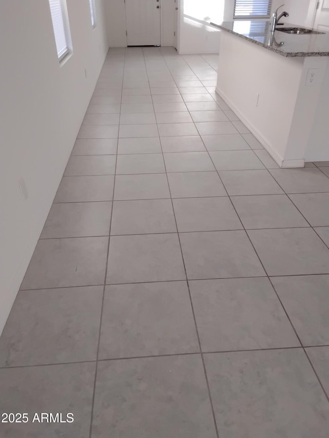 interior space with light tile patterned flooring and sink