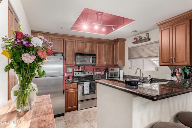 11375 E Sahuaro Dr Unit 1062, Scottsdale, AZ 85259 - kitchen with stainless steel appliances, brown cabinets, a sink, and light tile patterned flooring