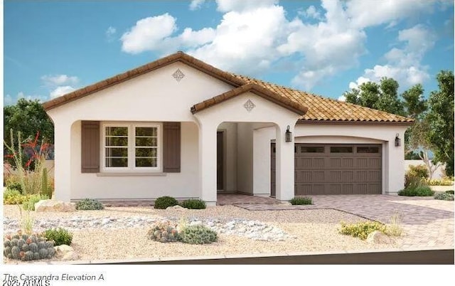 mediterranean / spanish home featuring a garage, a tiled roof, decorative driveway, and stucco siding