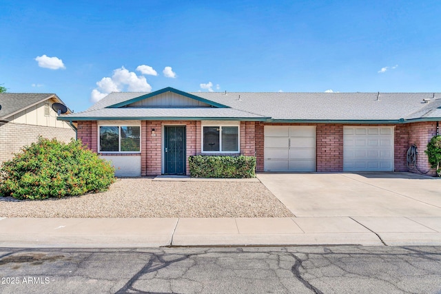 9639 W Cinnabar Ave Unit A, Peoria, AZ 85345 - view of front of property with an attached garage, concrete driveway, brick siding, and roof with shingles