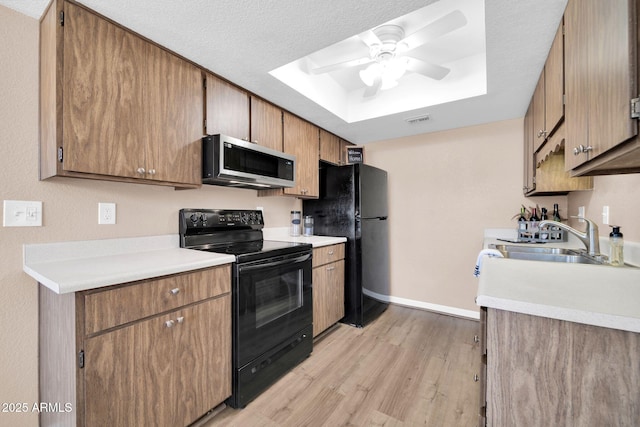 9639 W Cinnabar Ave Unit A, Peoria, AZ 85345 - kitchen featuring black appliances, a sink, ceiling fan, light wood finished floors, and a raised ceiling