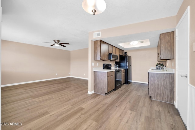 9639 W Cinnabar Ave Unit A, Peoria, AZ 85345 - kitchen featuring black appliances, light countertops, ceiling fan, light wood-style floors, and baseboards