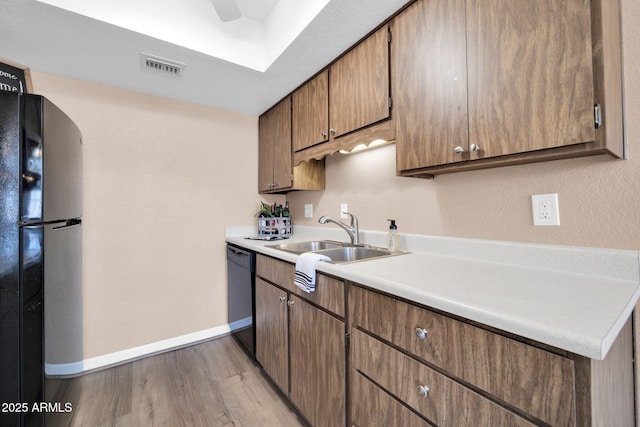 9639 W Cinnabar Ave Unit A, Peoria, AZ 85345 - kitchen featuring freestanding refrigerator, dishwasher, baseboards, a sink, and light wood-style flooring