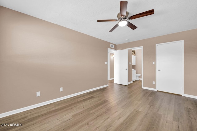 9639 W Cinnabar Ave Unit A, Peoria, AZ 85345 - unfurnished bedroom with wood finished floors, baseboards, ensuite bath, and ceiling fan
