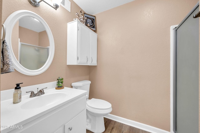 9639 W Cinnabar Ave Unit A, Peoria, AZ 85345 - bathroom featuring toilet, an enclosed shower, vanity, wood finished floors, and baseboards