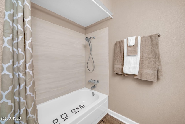 9639 W Cinnabar Ave Unit A, Peoria, AZ 85345 - bathroom featuring shower / tub combo, baseboards, and wood finished floors