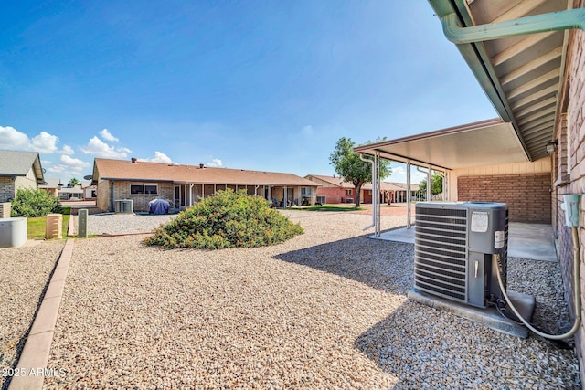 9639 W Cinnabar Ave Unit A, Peoria, AZ 85345 - view of yard featuring central AC unit, a patio area, and a residential view
