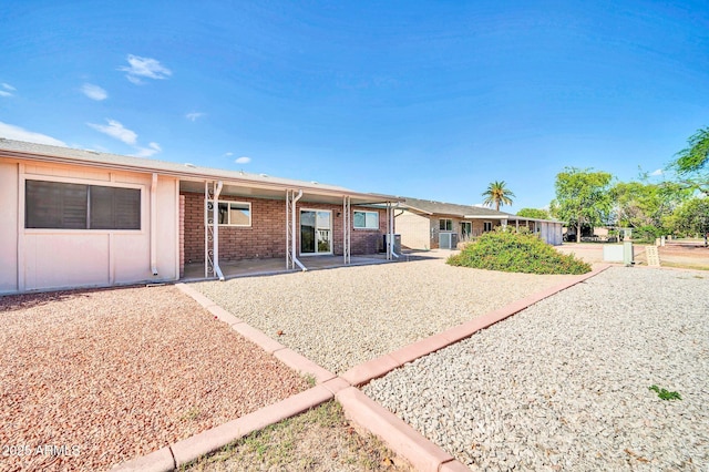 9639 W Cinnabar Ave Unit A, Peoria, AZ 85345 - rear view of property featuring a patio area and brick siding
