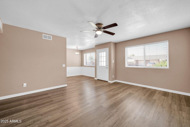9639 W Cinnabar Ave Unit A, Peoria, AZ 85345 - spare room with wood finished floors, ceiling fan, baseboards, and a textured ceiling