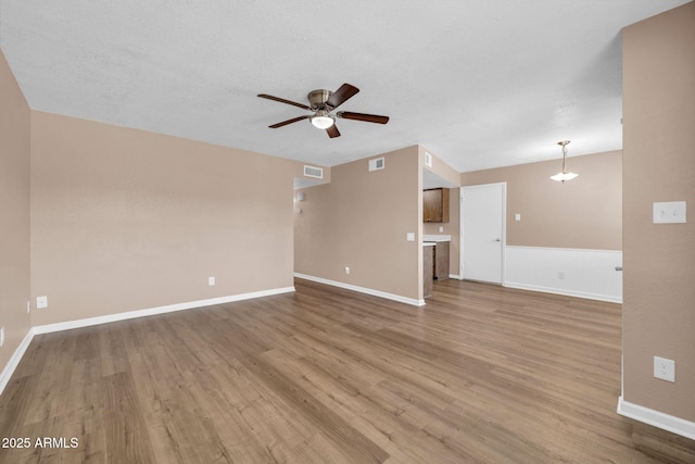 9639 W Cinnabar Ave Unit A, Peoria, AZ 85345 - unfurnished living room with ceiling fan, wood finished floors, and baseboards