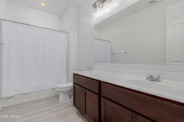 full bathroom featuring vanity, wood-type flooring, toilet, and shower / bathtub combination with curtain