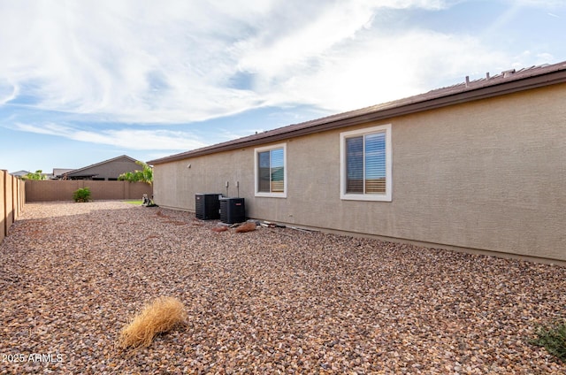 rear view of property with cooling unit