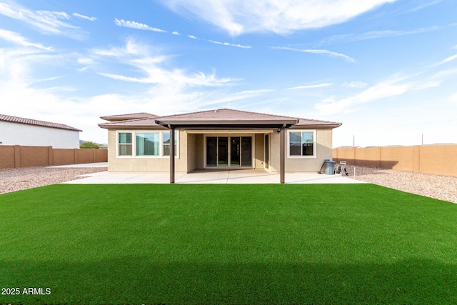 rear view of house featuring a patio and a lawn