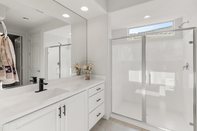 bathroom featuring vanity, tile patterned flooring, and a shower with door