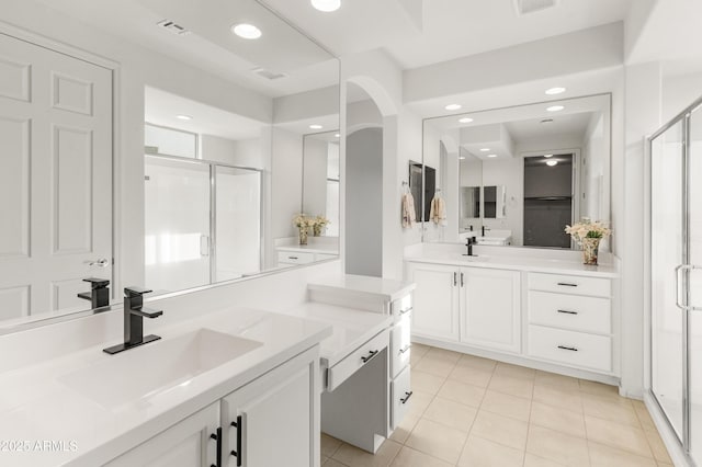 bathroom featuring tile patterned floors, vanity, and a shower with shower door