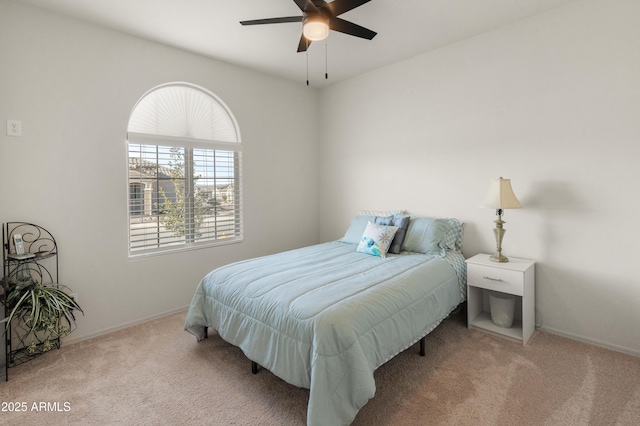 bedroom with ceiling fan and light colored carpet