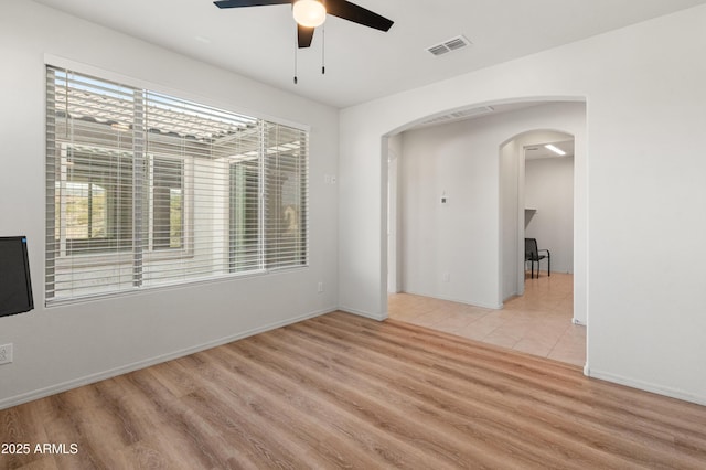 empty room featuring ceiling fan and light hardwood / wood-style flooring