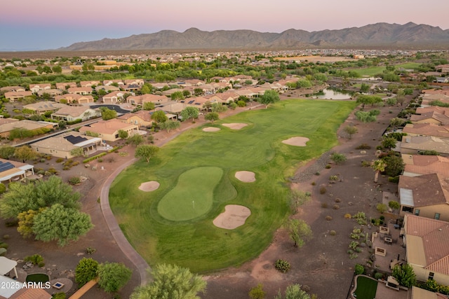 aerial view at dusk featuring a mountain view