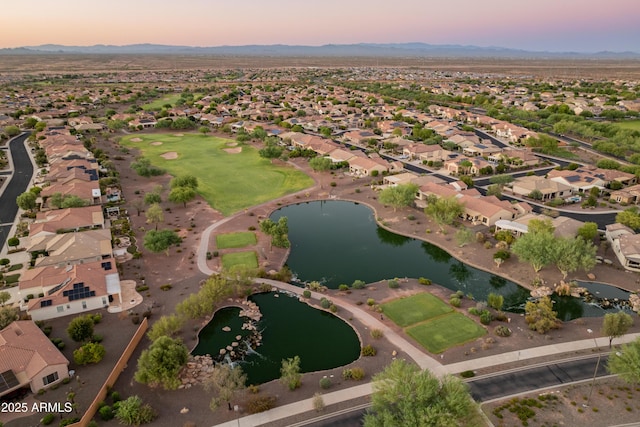 aerial view at dusk with a water view