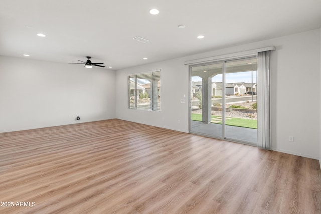 spare room featuring ceiling fan and light wood-type flooring