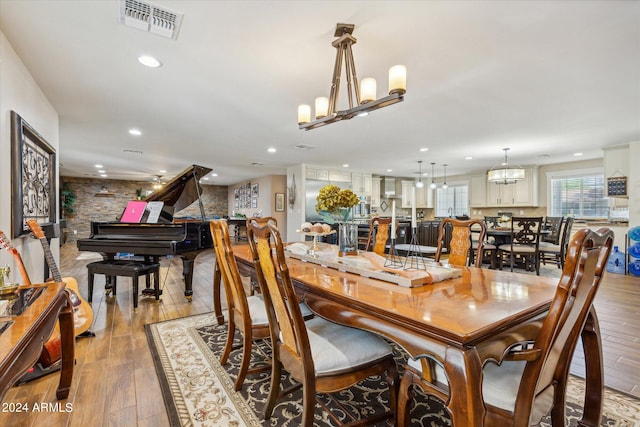 dining room featuring a chandelier and light hardwood / wood-style flooring