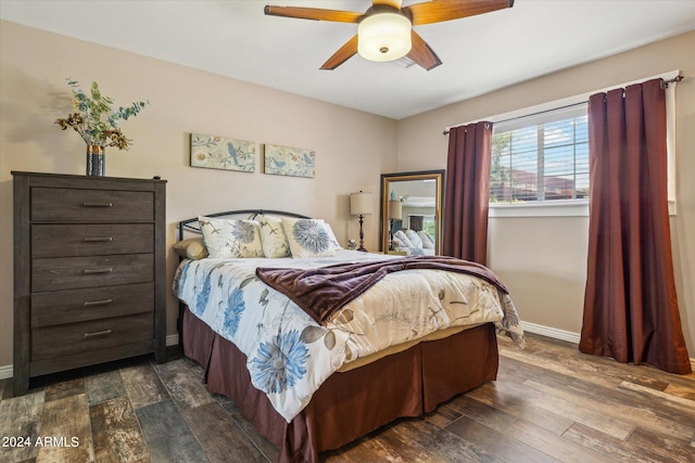 bedroom featuring ceiling fan and dark hardwood / wood-style floors