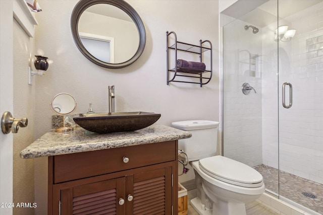 bathroom with vanity, walk in shower, and toilet