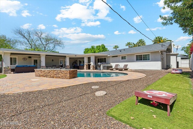 view of pool featuring a lawn and a patio area