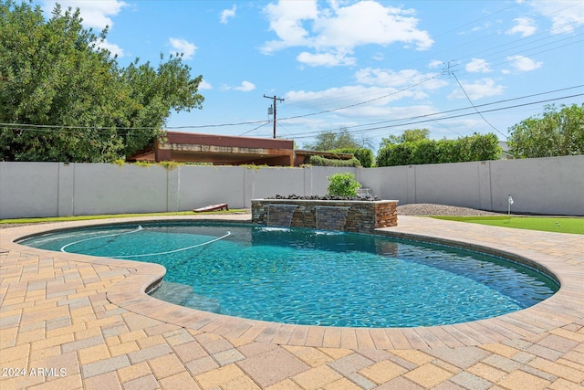 view of pool with a patio and pool water feature