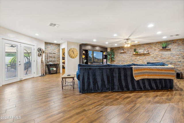 living room featuring french doors, hardwood / wood-style floors, and ceiling fan