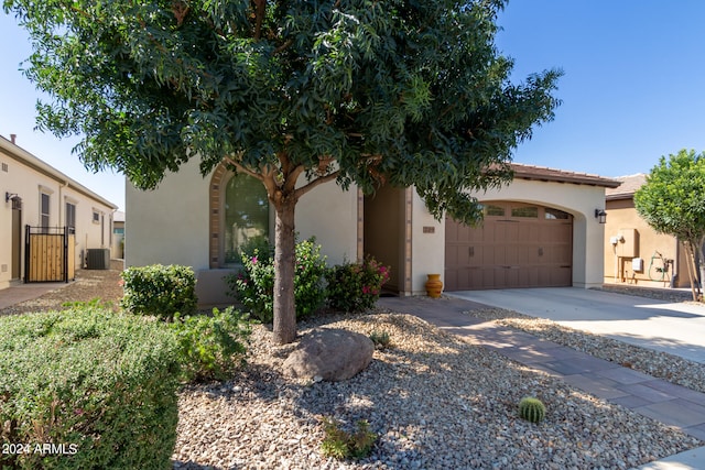 mediterranean / spanish home featuring central AC unit and a garage