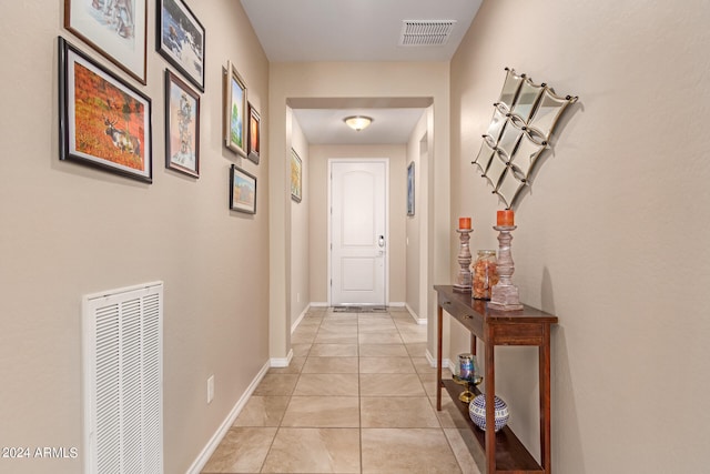 corridor featuring light tile patterned floors