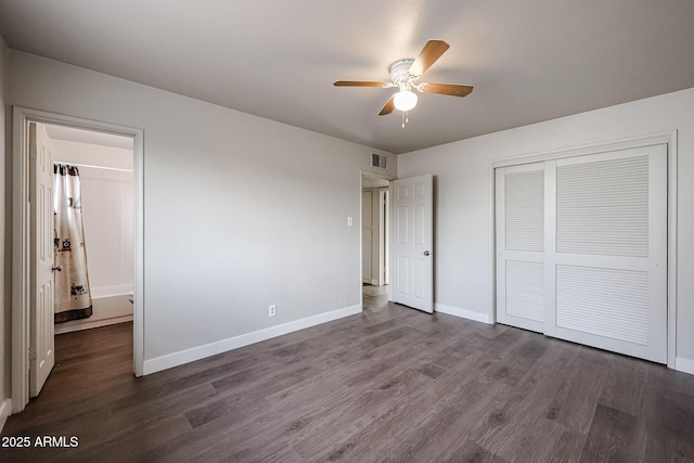 unfurnished bedroom featuring ceiling fan, dark wood-type flooring, and a closet