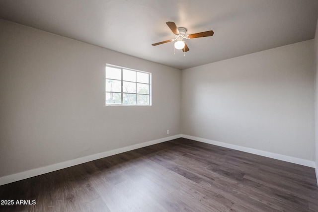 empty room featuring ceiling fan and dark wood-type flooring