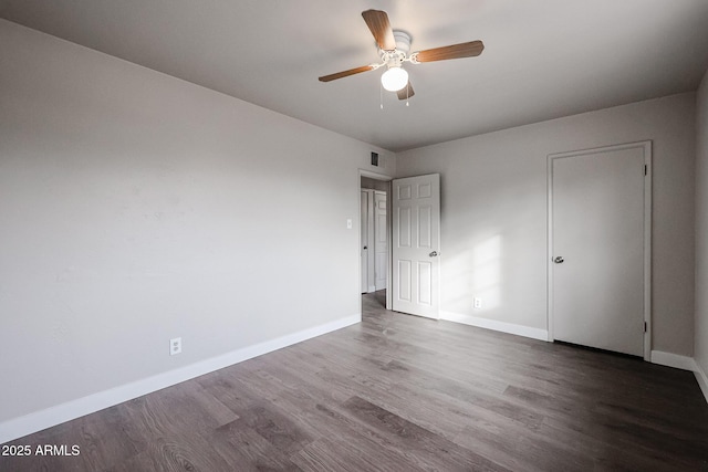 unfurnished room featuring ceiling fan and dark hardwood / wood-style flooring