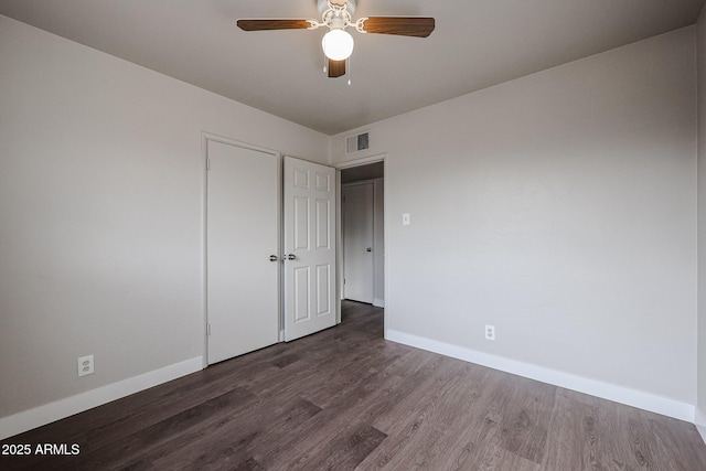 unfurnished bedroom with ceiling fan and dark hardwood / wood-style floors