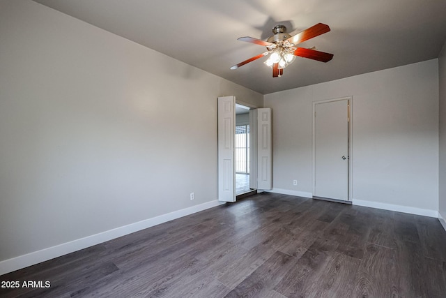 spare room with ceiling fan and dark hardwood / wood-style flooring