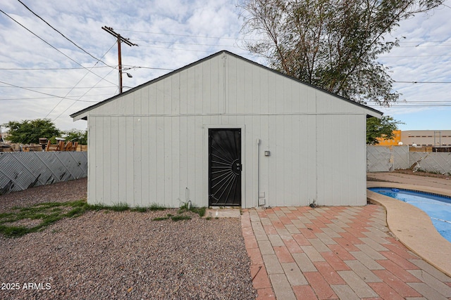 view of outbuilding with a fenced in pool