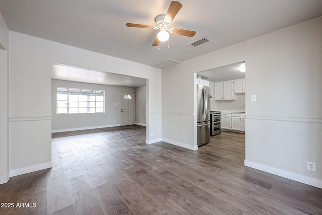 unfurnished living room with hardwood / wood-style flooring and ceiling fan