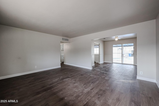 spare room featuring ceiling fan and dark wood-type flooring