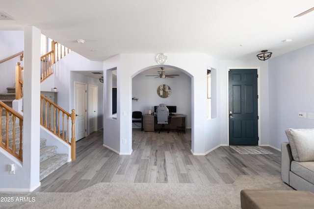 foyer with ceiling fan and light hardwood / wood-style floors