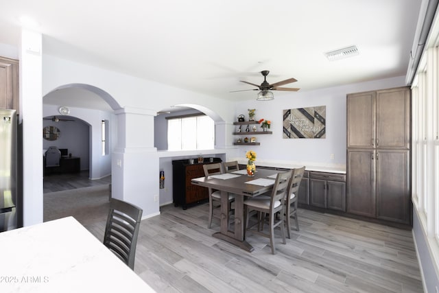 dining area with ceiling fan and light hardwood / wood-style flooring