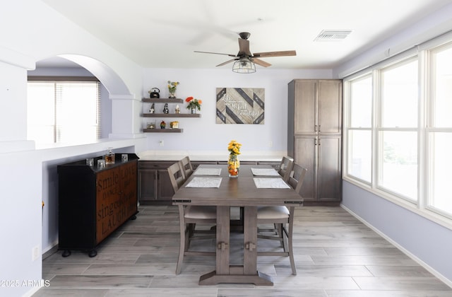 dining area with ceiling fan and light hardwood / wood-style floors