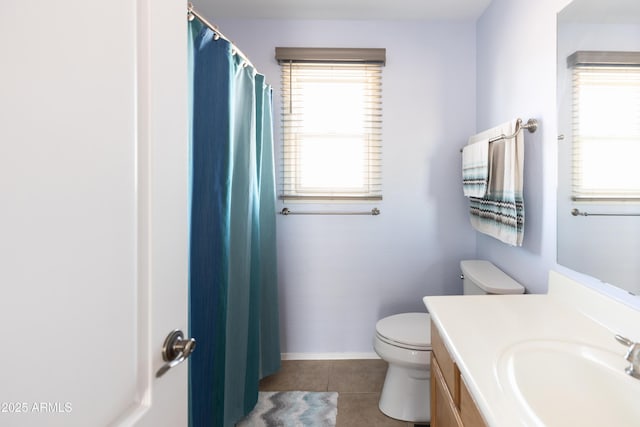 bathroom with vanity, toilet, tile patterned flooring, and a wealth of natural light